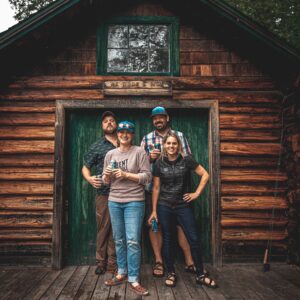 Bent Paddle Brewing Co-Founders in front of cabin