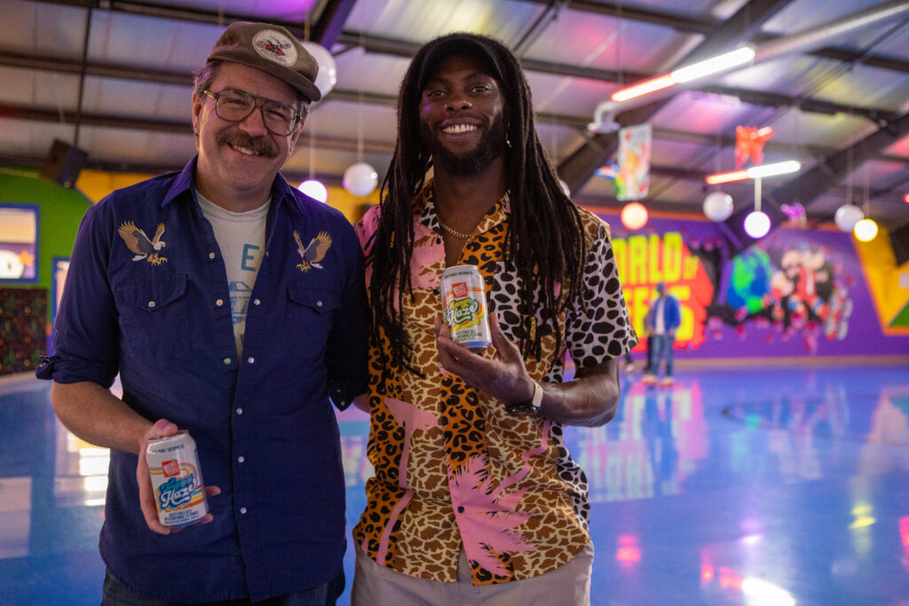 two people standing at rolling rink both holding on flavor of the retro haze variety pack